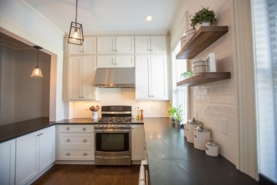 Photo gallery of remodeled kitchen features CliqStudios Shaker Painted White cabinets with nickel finish cup pulls