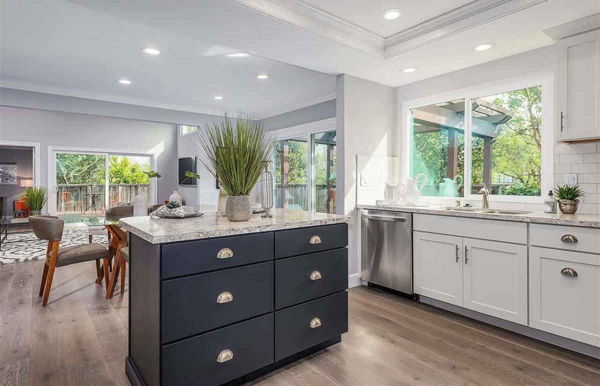 White shaker kitchen cabinets with blue island