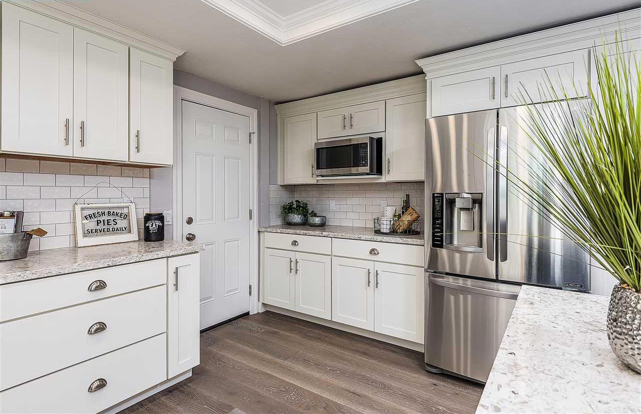 White shaker kitchen cabinets with light countertops