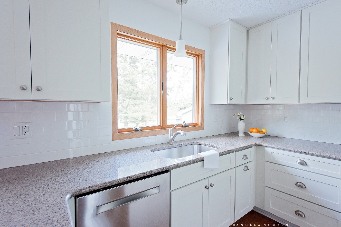 white kitchen cabinets under sink with stainless dishwasher and drawer base