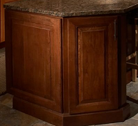 end view of cherry cabinets in kitchen island, with ends finished with door panels