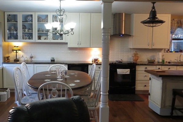 vintage kitchen design based on white shaker cabinets and reclaimed island, painted dining table and eclectic decor