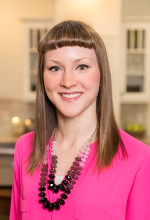 kitchen designer erin lubbe, young woman in pink suit has long har with bangs