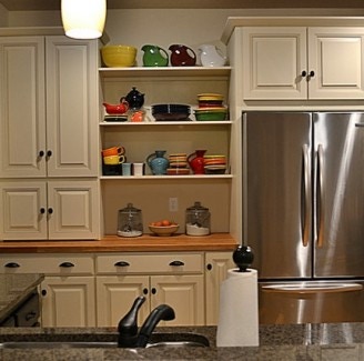 built in desk and hutch features open shelving and traditional raised panel doors in cream