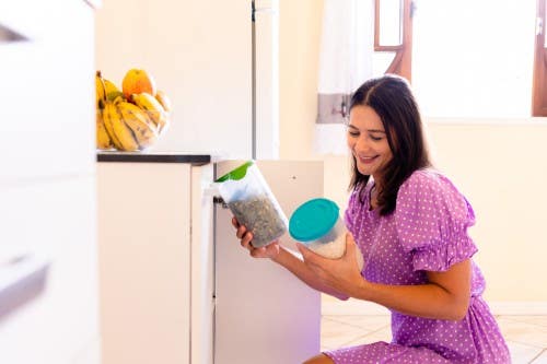 Smiling woman organizing her kitchen