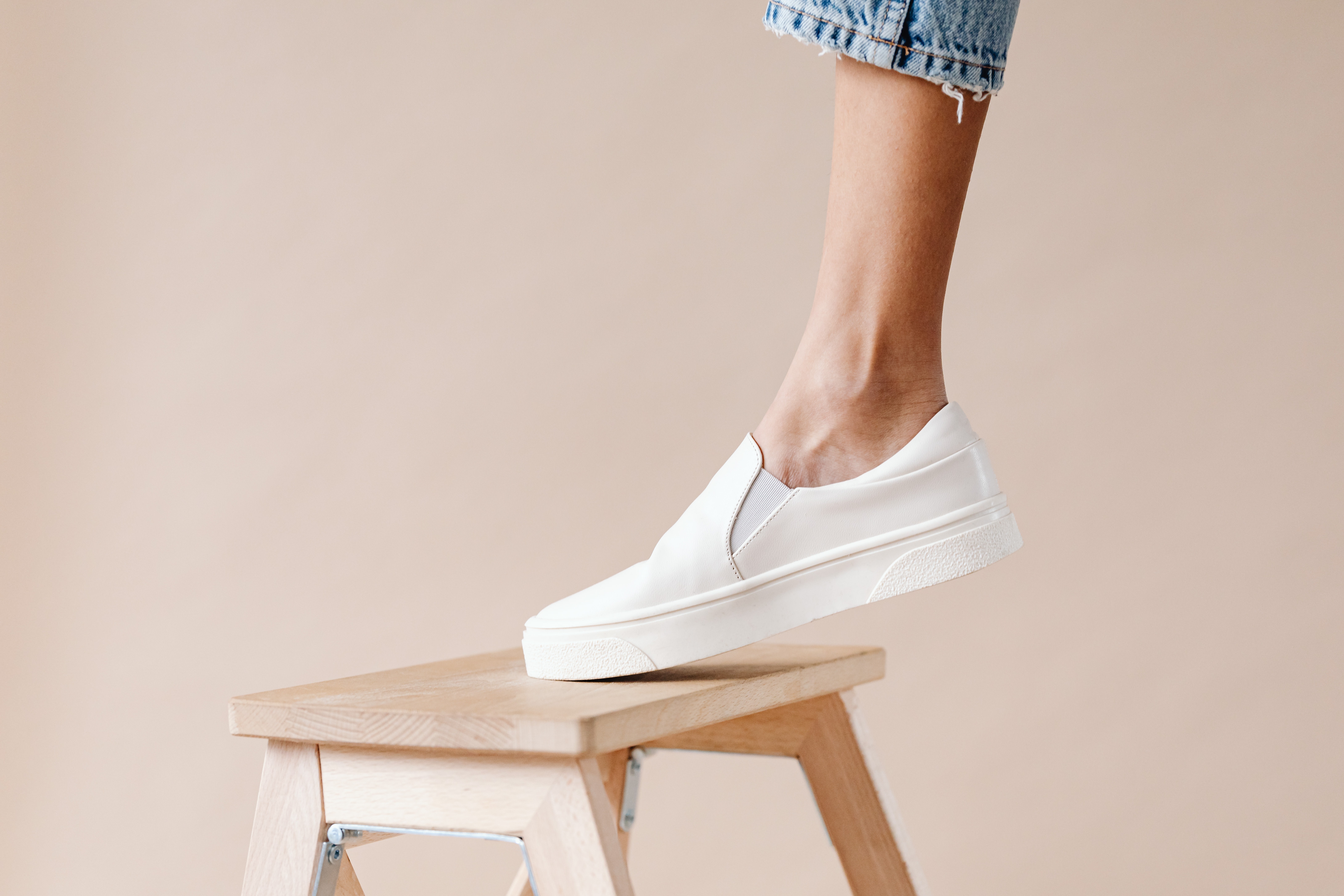 Person standing on a foldable step stool