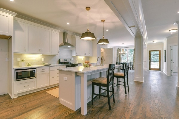 White shaker kitchen cabinets and furniture island with legs