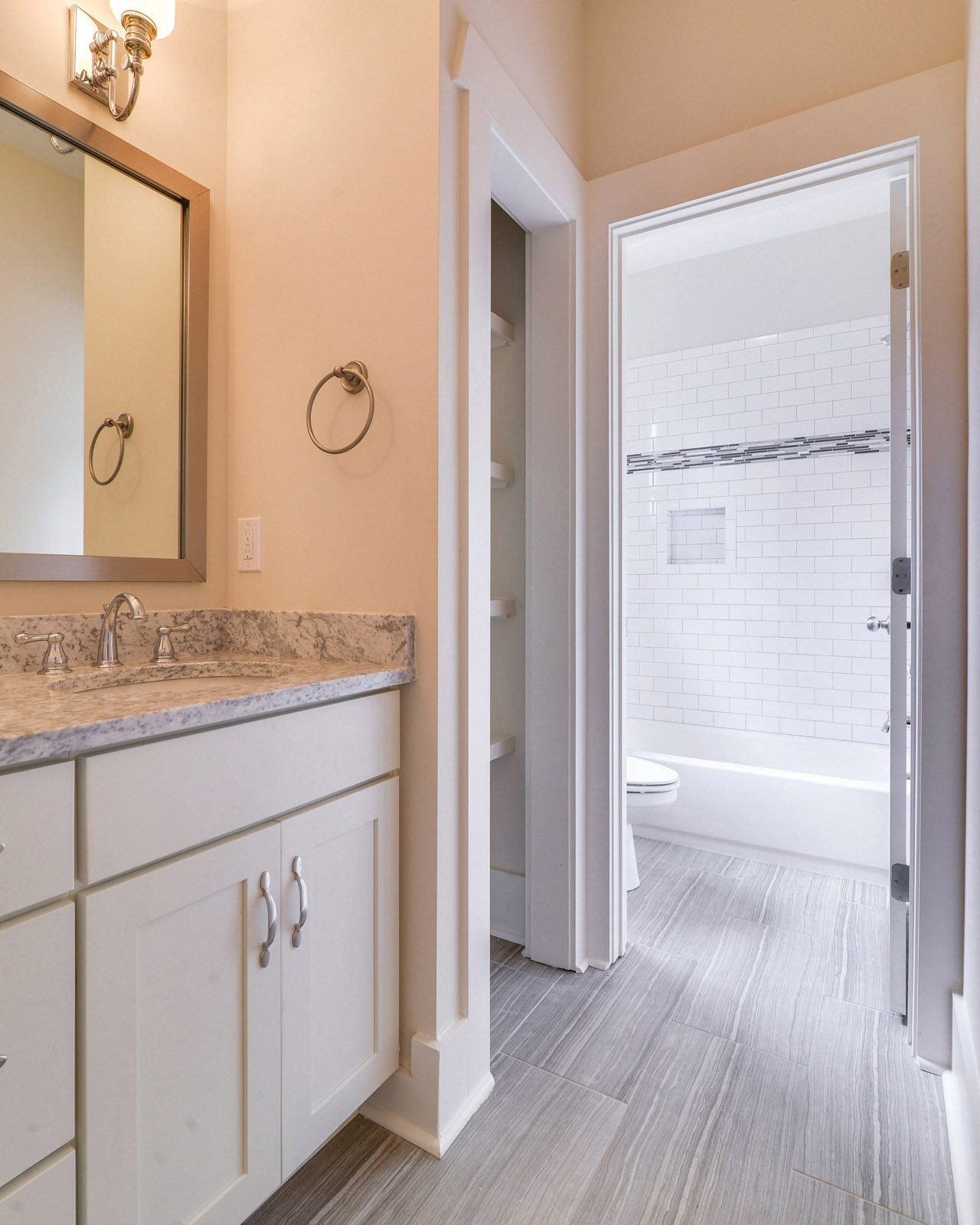 CliqStudios bath cabinets shown in Shaker White door style and finish