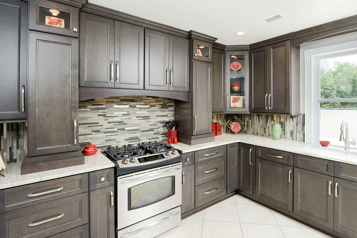 Medium gray wood kitchen cabinets in L-shaped cabinet layout