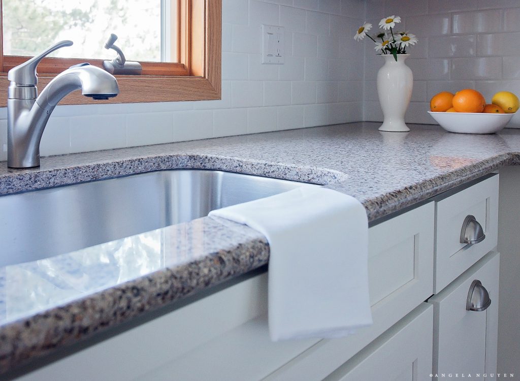 sink base of white cabinets with granite countertop