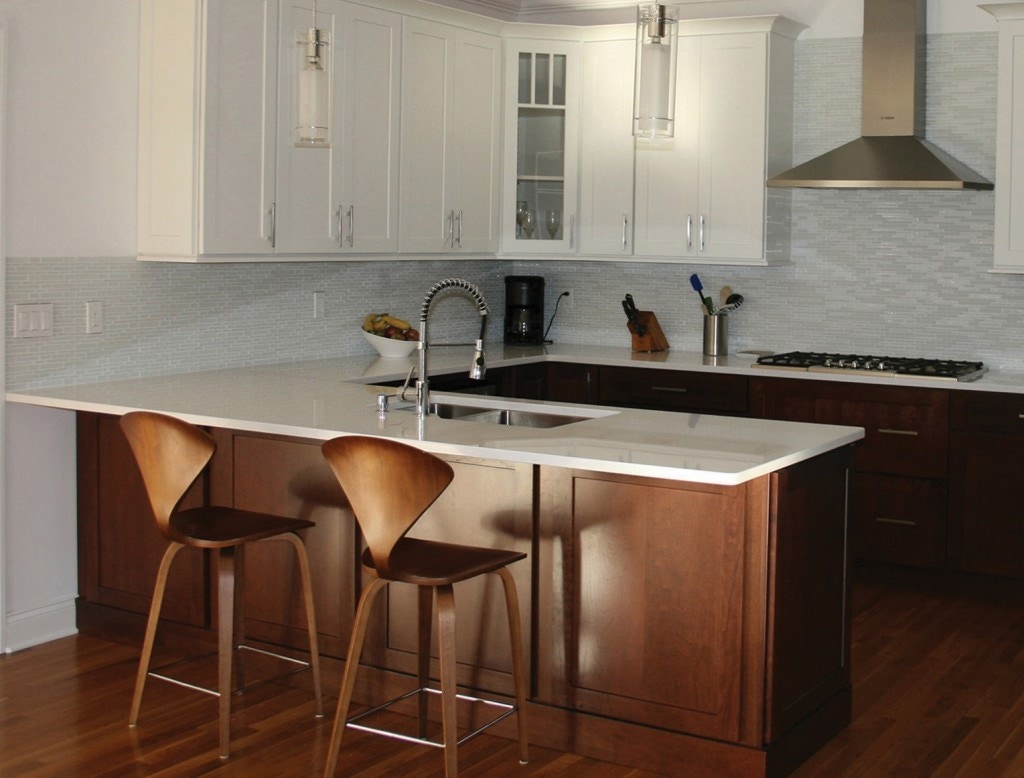 Maple base cabinets and peninsula and white shaker wall cabinets in this kitchen with peninsula u shape