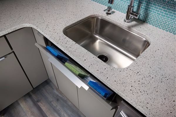 Sink tip out tray in gray slab cabinets.