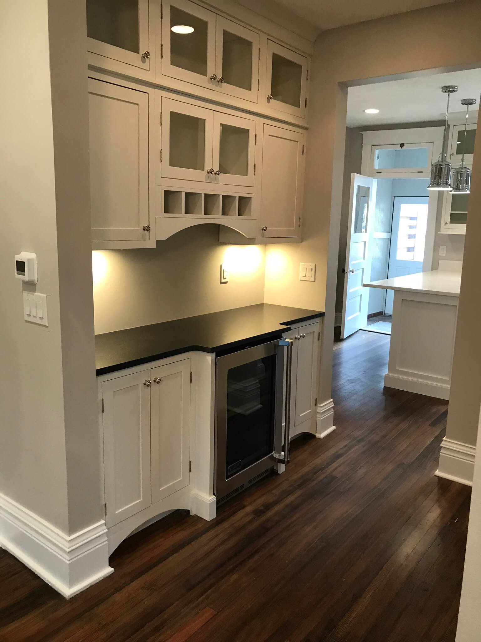 This image is of vintage bar cabinets in a house. If you are drawn to a more eclectic or retro-inspired interior design style, you can create a vintage bar cabinet design within your own home.