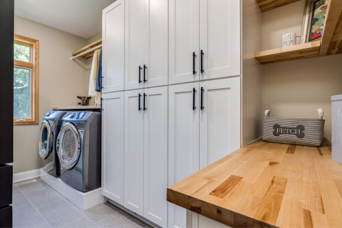 White shaker laundry room cabinets