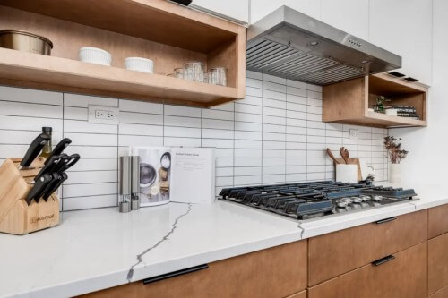 White and light wood slab cabinet door kitchen with white uppers and wood base cabinets